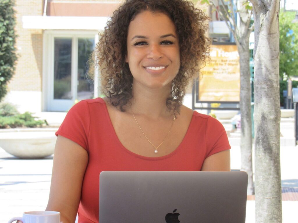 Chelsey Opare-Addo working on laptop outdoors